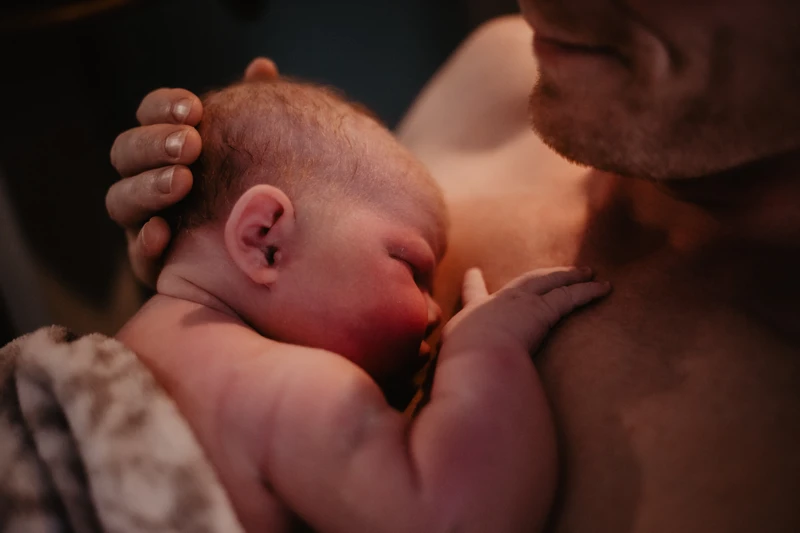 Newborn baby on father's chest 